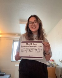 LNHeadshot Image_200x250 Lindsey Nguyen holding a sign that says