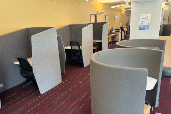 a room with study cubicles and chairs