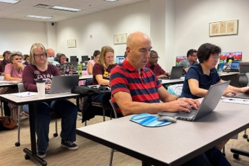 Low angle shot of faculty members working on their laptops in a library instruction classroom