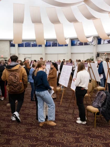 a group of people looking at a poster