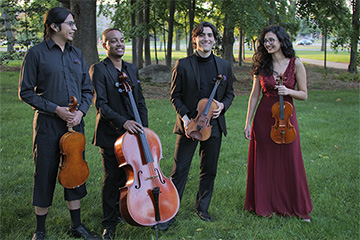 A group of four people holding instruments