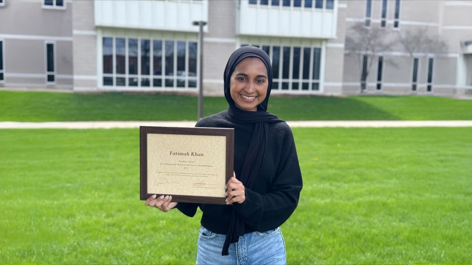 A woman holding an award.