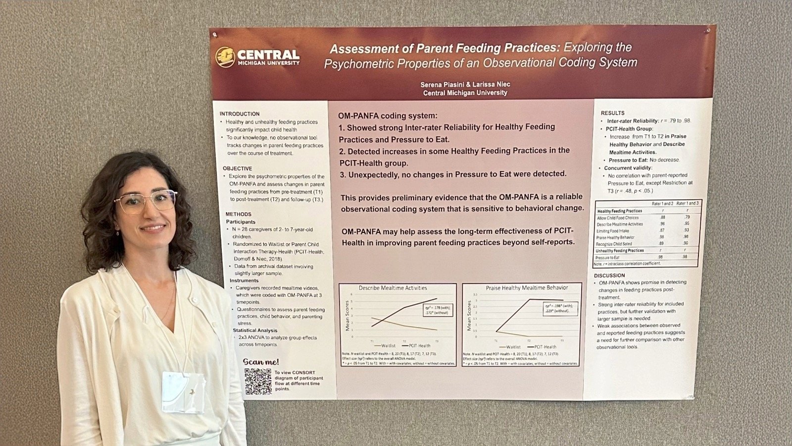 a woman standing in front of a poster