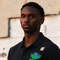 Carnell_Poindexter_200x200 Carnell Poindexter in a professional headshot wearing a black Inner City Inclusion polo, standing outdoors against a neutral wall.