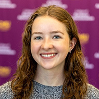 Holly_Ireton_200x200 Holly Ireton smiling in a professional headshot, with a blurred maroon CMU backdrop.