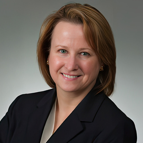 Sarah Opperman wears a cream shirt and black blazer.