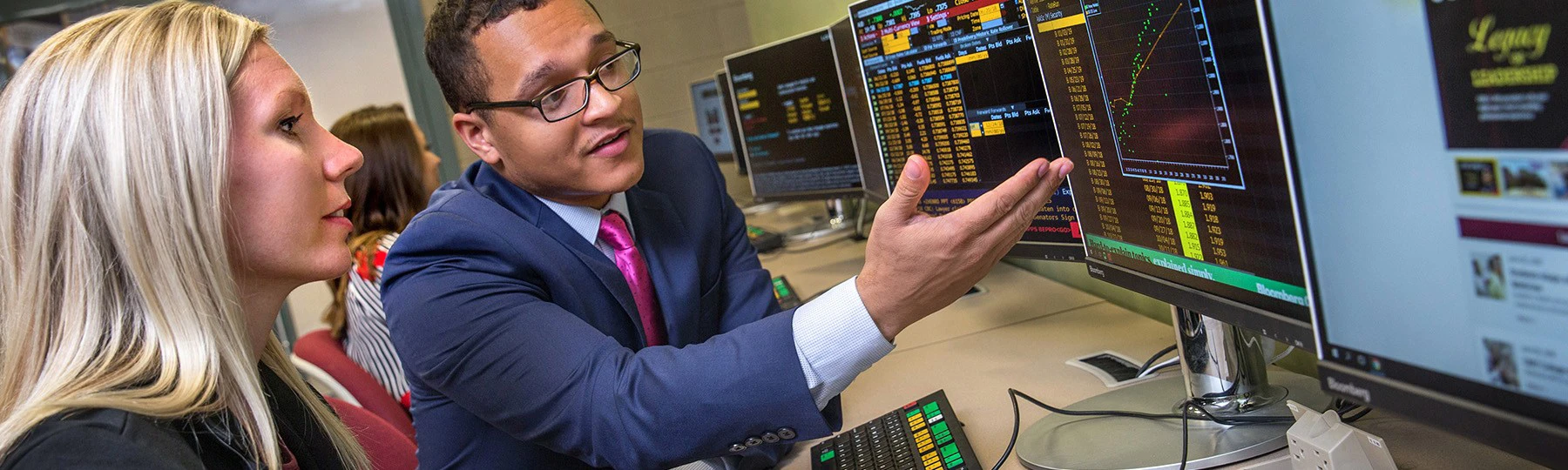 Two people reviewing data on a screen