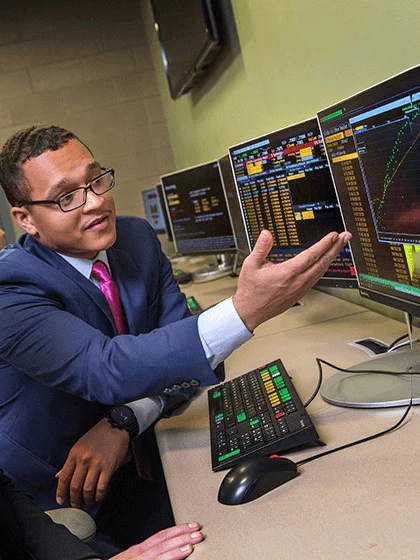 a man in a suit looking at a computer screen