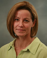 Headshot of Leslie Francke wearing a light green collared shirt.