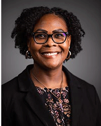 Photo of Donnesha Blake wearing a flowered blouse and dark blazer