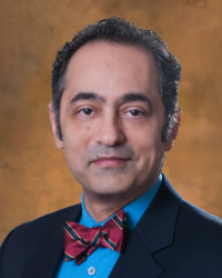 a man in a suit and bow tie