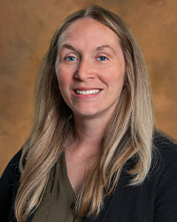 Natole a woman with long blonde hair smiling