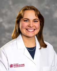 Gray, Elizabeth 200 x 250 web A female medical student in a white lab coat embroidered with a Central Michigan University College of Medicine logo.
