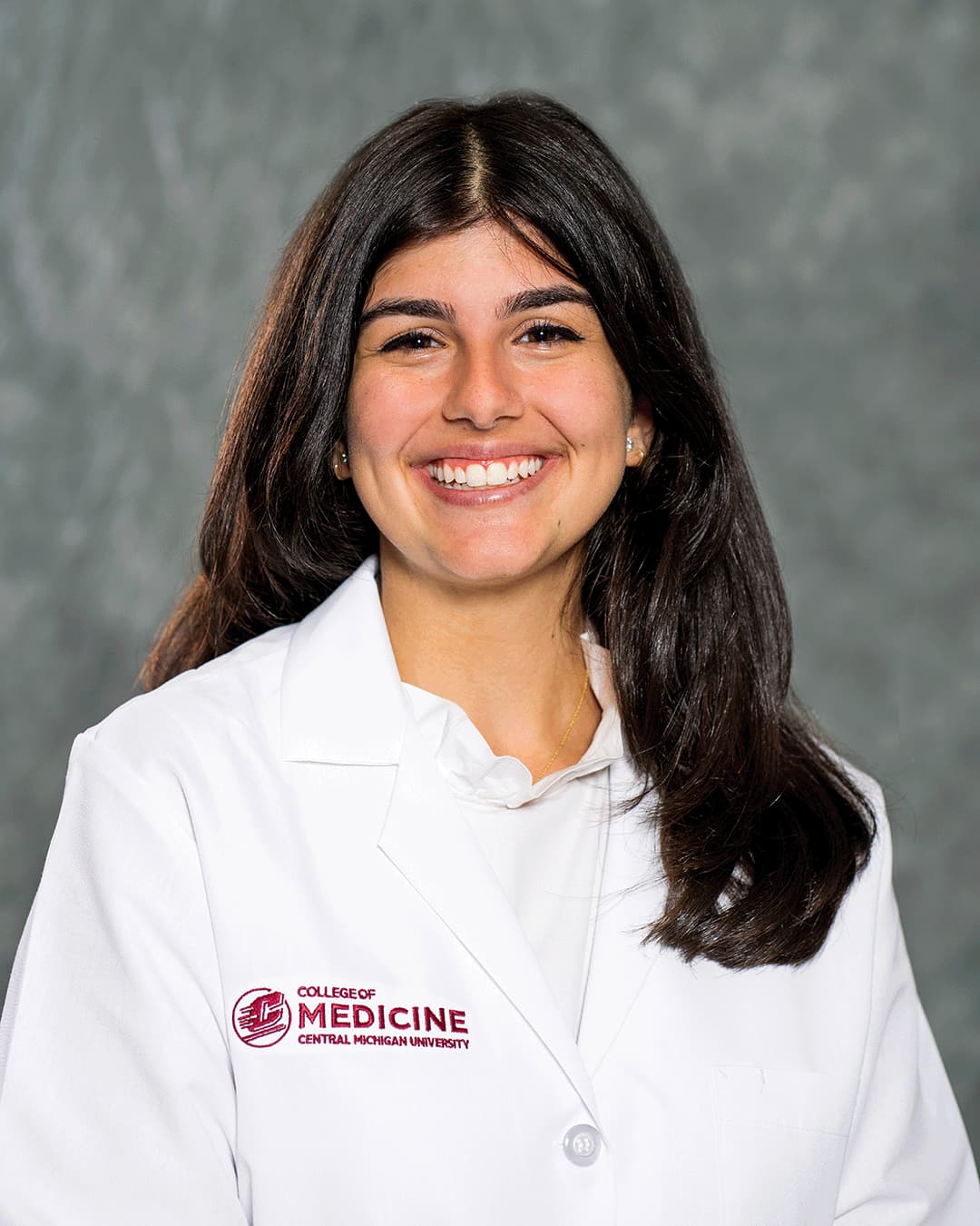 Moufawad, Michelle 200 x 250 web A female CMU College of Medicine medical student wearing her white coat as she smiles for the camera.