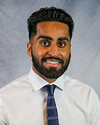 Headshot of Mehtab Galeh wearing a white dress shirt and a blue striped necktie.