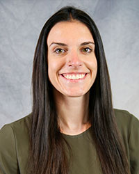 Headshot of Dakota Nerland wearing an olive colored blouse.