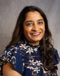 A woman wearing a blue floral shirt.