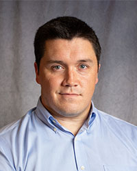 Daniel Evans is wearing a blue button down shirt.