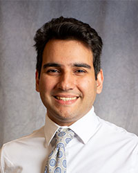 Wassim Jamaleddine is wearing a white button-down shirt and a patterned tie.