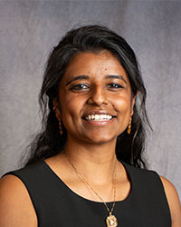 Kaavya Puttagunta is wearing a black sleeveless blouse with long dark hair.