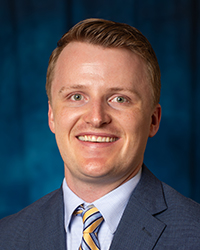 a man in a suit smiling