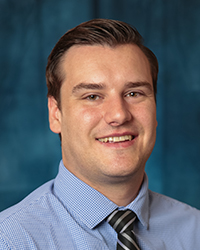 a man in a blue shirt and tie