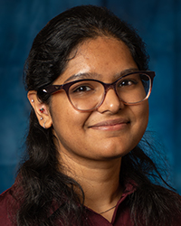 a woman with long hair wearing glasses
