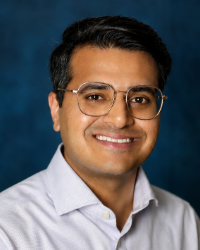 a man wearing glasses and a white shirt