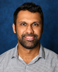 a man with a beard and grey shirt