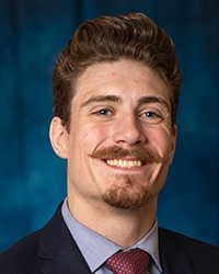a man with a mustache smiling