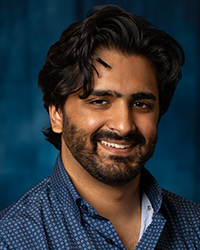 a man with a beard smiling