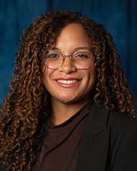 a woman with curly hair wearing glasses