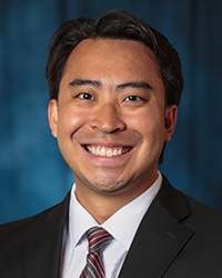 a man in a suit smiling