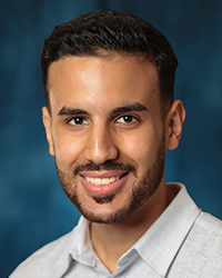 a man with a beard smiling