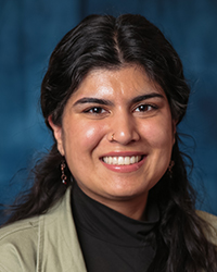 a woman smiling with a black turtleneck