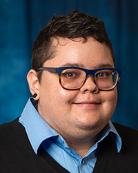 a person wearing glasses and a suit