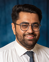 a man wearing glasses and a white shirt