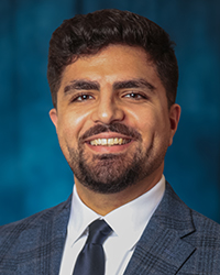 a man in a suit smiling