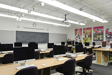 Wightman Hall computer lab, computers in rows, chalk board at front, posters along the wall