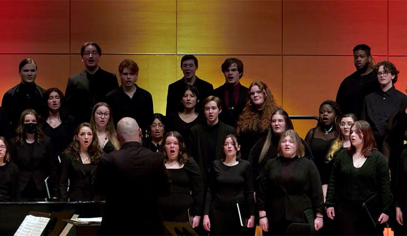 The combined CMU Choir performing in Staples Family Concert Hall under the direction of Dr. Amon Eady.