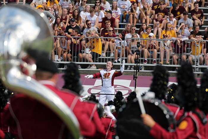 A picture of the Chippewa Marching Band Drum Major Jordan Healey conducting the band