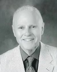 Greyscale headshot of Guy Meiss. There's a crooked white frame around the picture.