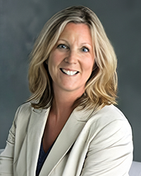 Headshot of Kallie Bila Michels on a soft grey backdrop.