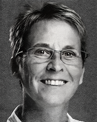 Greyscale headshot of Mary Ullmer. There's a crooked white frame around the picture.