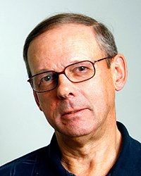 20230629_SCJMAlum_JohnHartman_001_200x250 Headshot of John Hartman on a light grey backdrop.