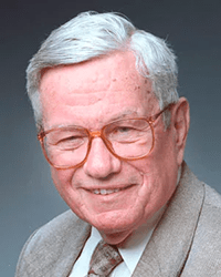 Headshot of Guido Stempel III in a suit and tie in front of a dark grey backdrop
