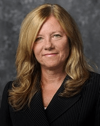 Headshot of Sandra Petykiewicz in front of a dar grey backdrop