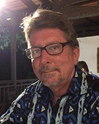 Headshot of Jim Reindl wearing a Hawaiian shirt