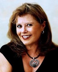 Headshot of Michelle Bearden in front of a soft blue backdrop