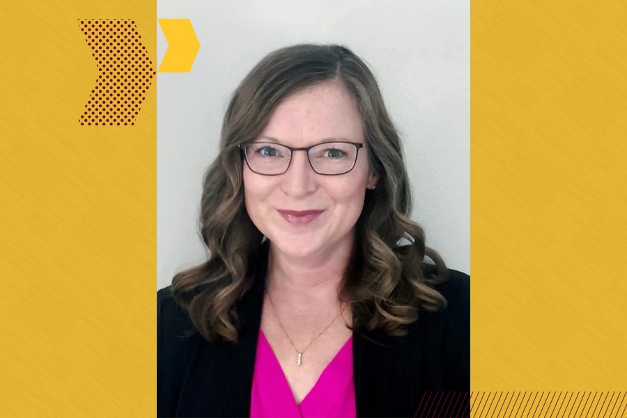 a woman wearing glasses and a pink shirt